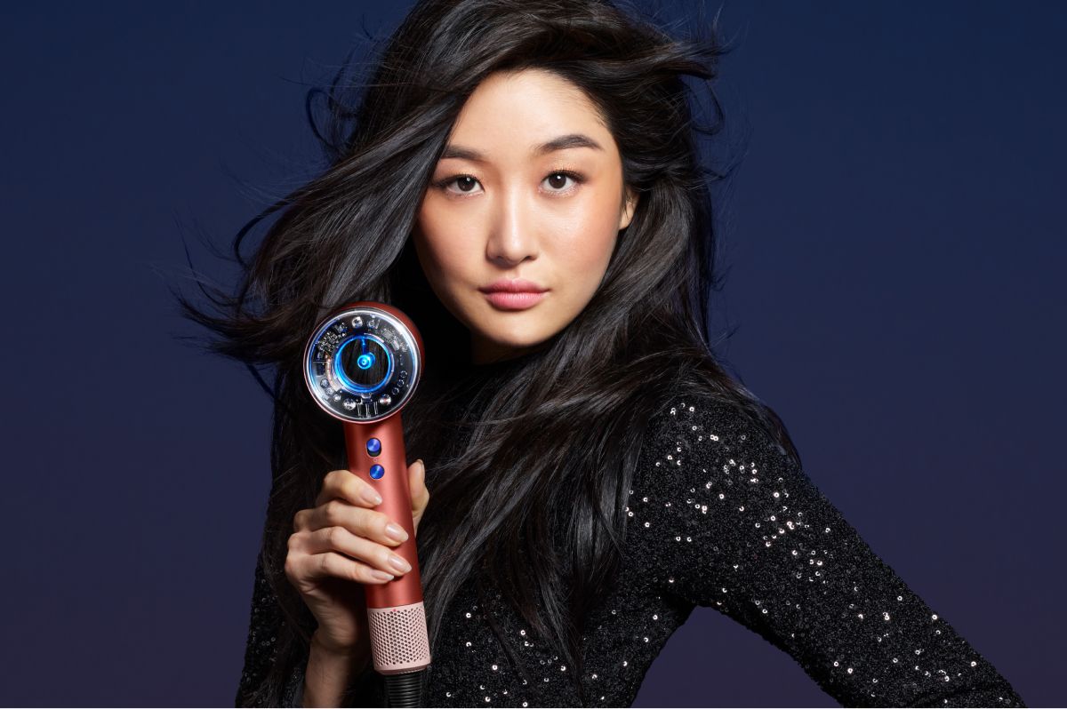 Model holding the Supersonic Nural hair dryer