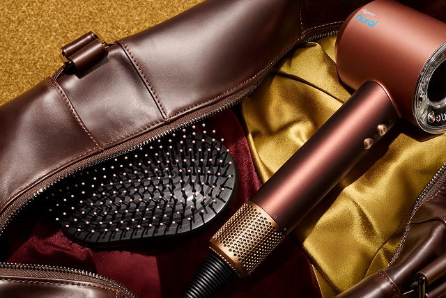 Dyson Supersonic Nural hair dryer and a Dyson brush in a leather bag.