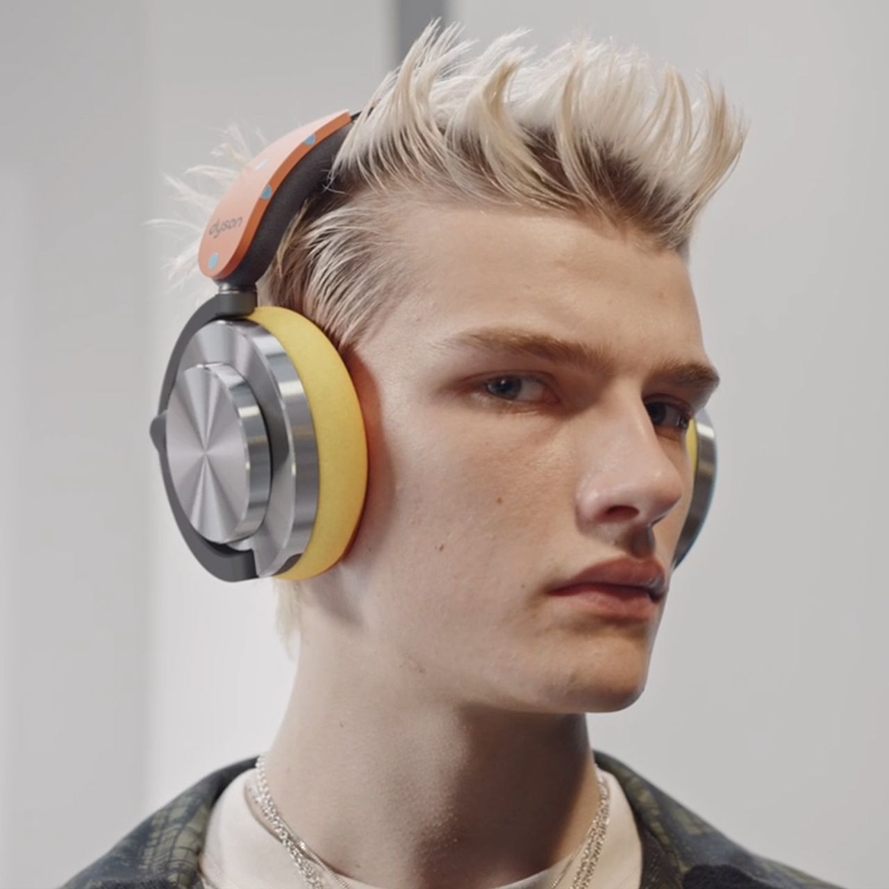 A model wearing Dyson OnTrac headphones.