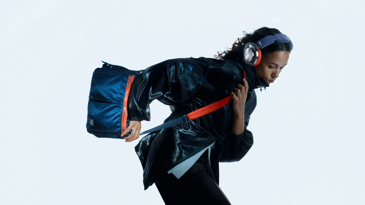 Model showcases Dyson OnTrac and PORTER custom shoulder bag in an active position.