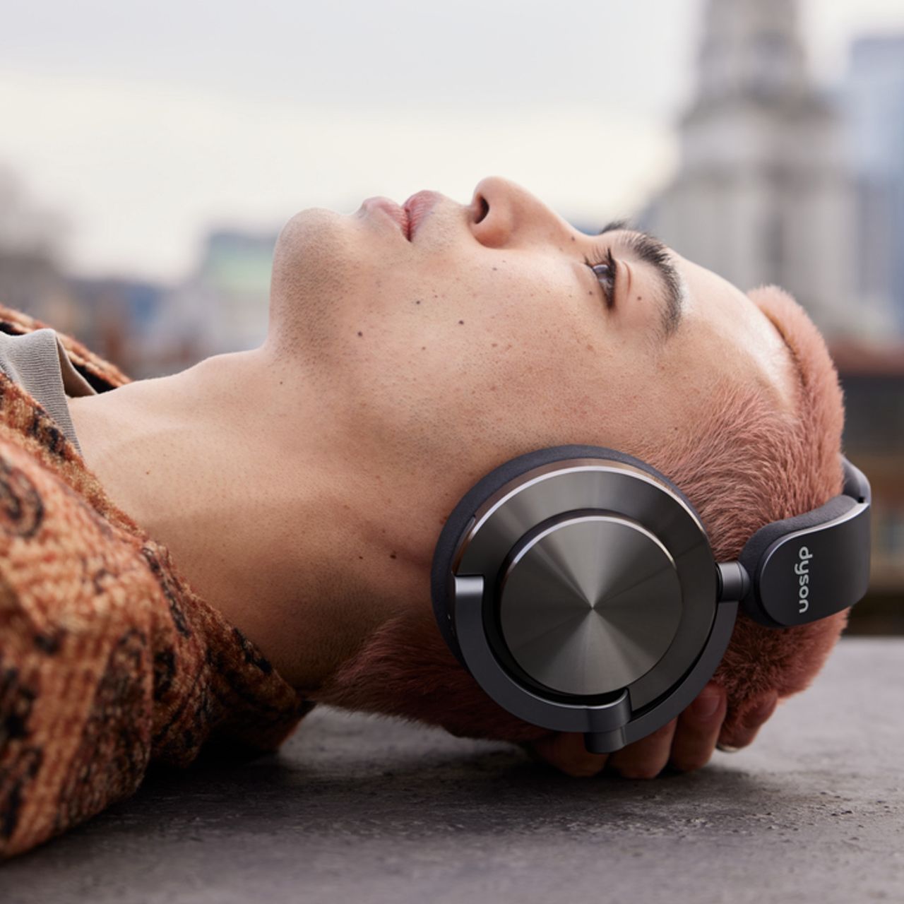 A model wearing Dyson OnTrac headphones.