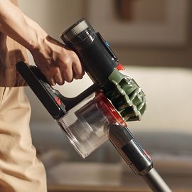 The Dyson V8 Cyclone cordless vacuum used to clean in a home.