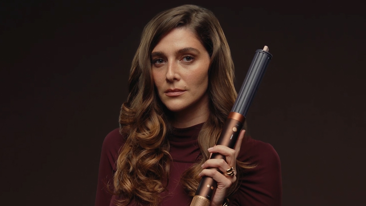 Model holds the Dyson Airwrap Co-anda2x multi-styler and dryer