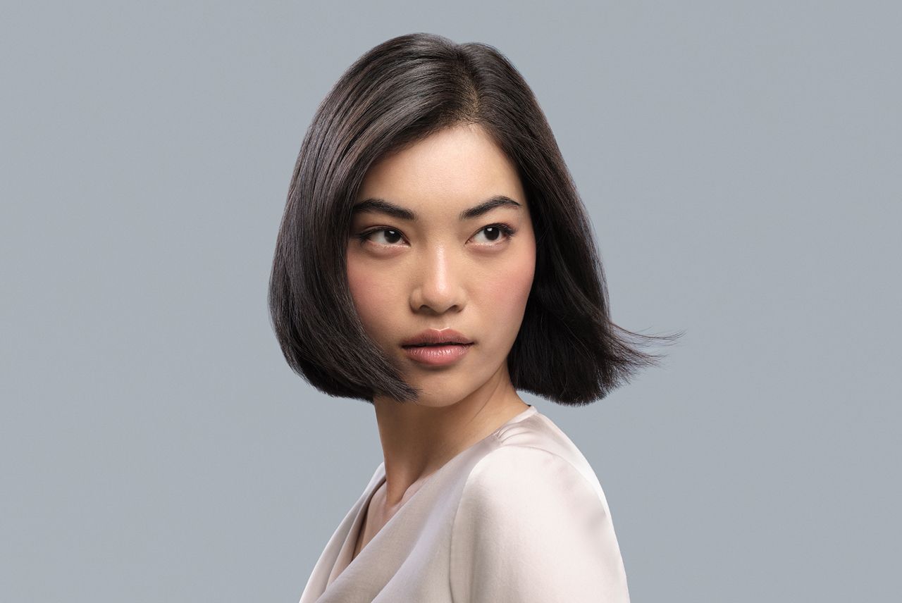 Model with chin-length dark hair in a Sleek and blunt style.