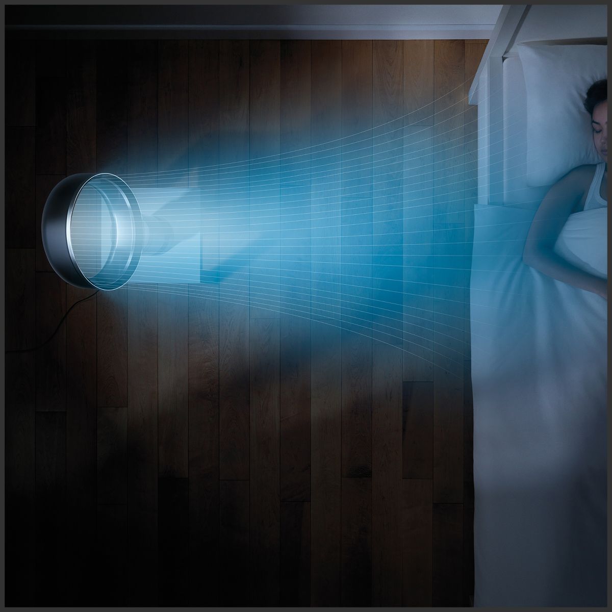 A Dyson purifying fan quietly operates next to a sleeping person.